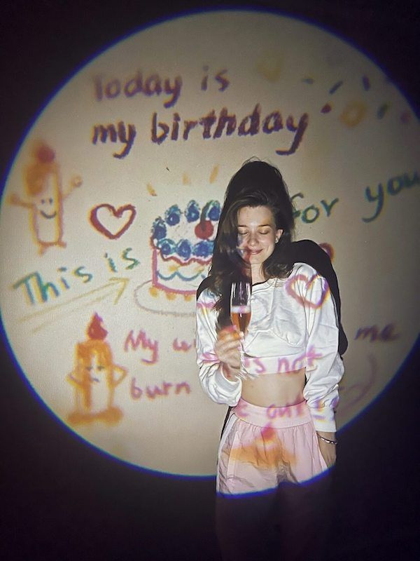 A birthday portrait in front of a handmade birthday backdrop