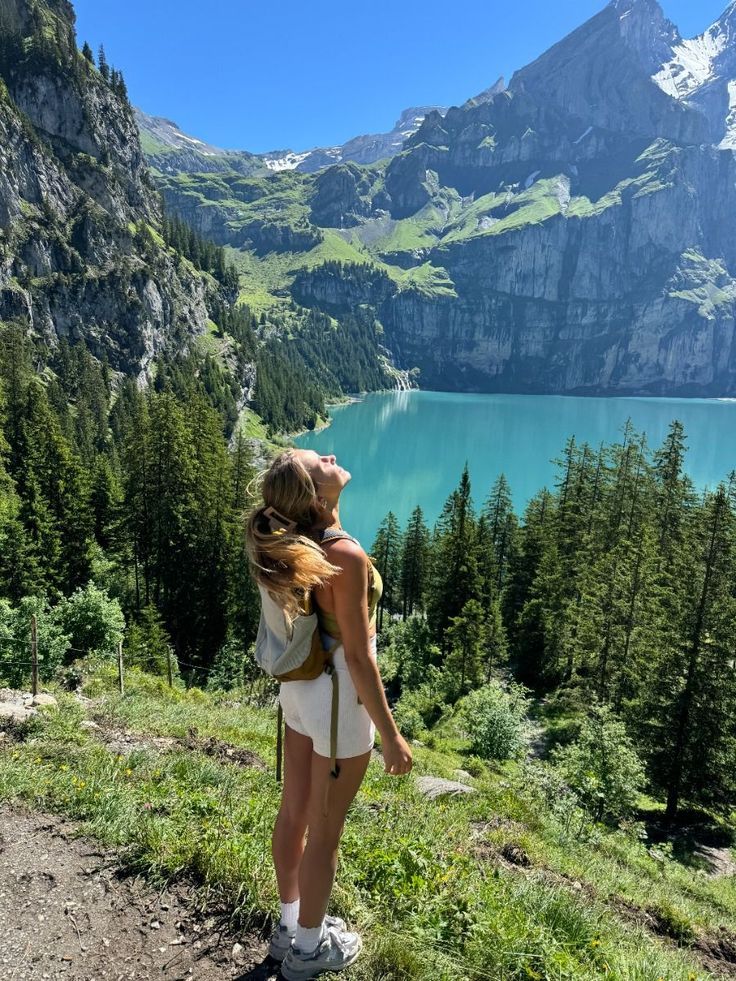 A traveler beside a mountain lake